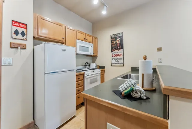 a kitchen with stainless steel appliances a refrigerator and a sink