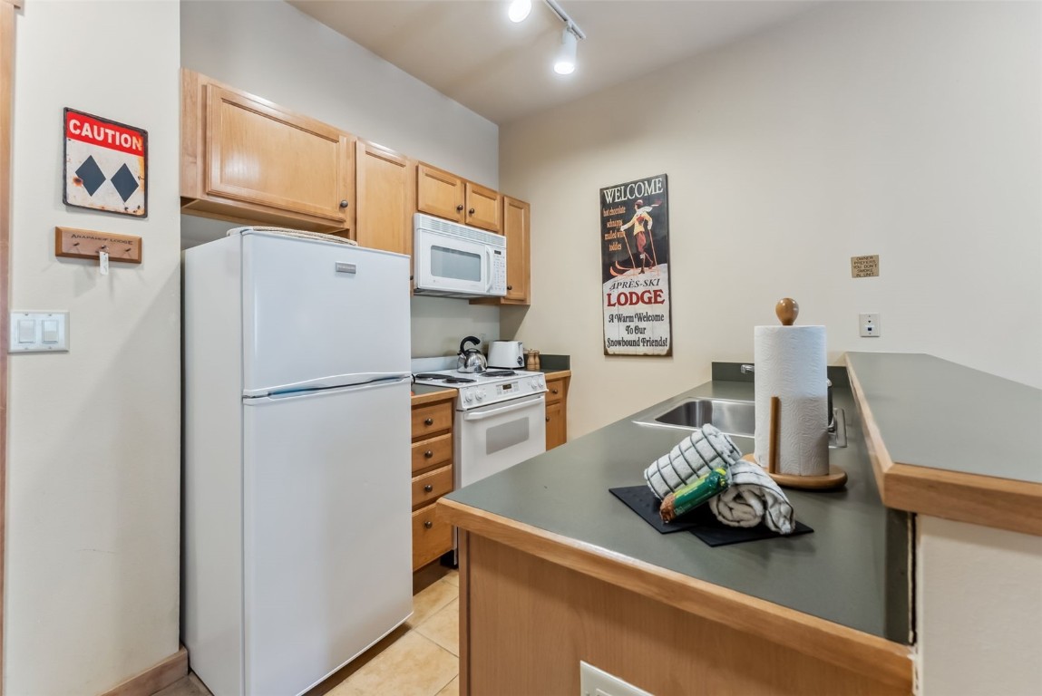 91 River Run Road, Unit 8117 Keystone, CO 80435 - Photo 6 of 17 a kitchen with stainless steel appliances a refrigerator and a sink