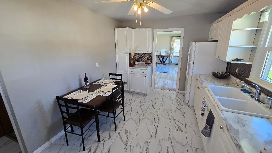 1124 13th Avenue Fulton, IL 61252 - Photo 12 of 27 a kitchen with a sink cabinets and refrigerator