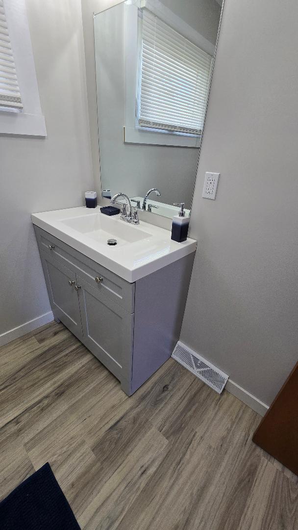 1124 13th Avenue Fulton, IL 61252 - Photo 15 of 27 a utility room with a sink window and wooden floor
