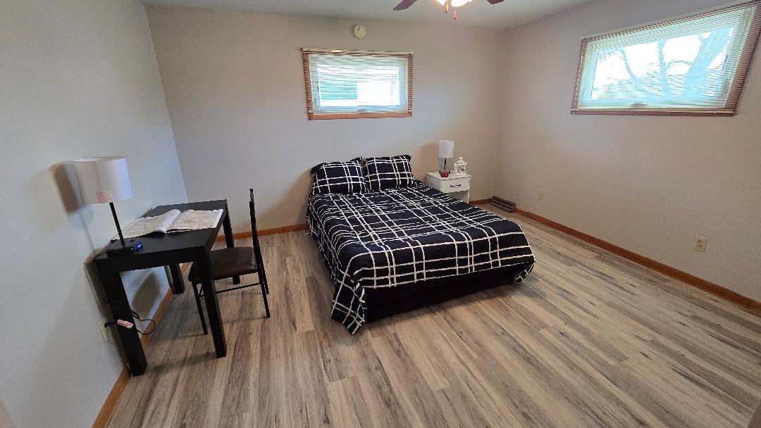 1124 13th Avenue Fulton, IL 61252 - Photo 18 of 27 a bedroom with a bed a dresser and chair