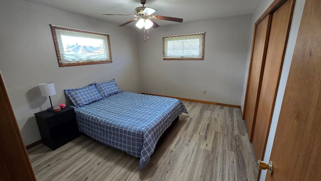 1124 13th Avenue Fulton, IL 61252 - Photo 19 of 27 a bedroom with bed and wooden floor
