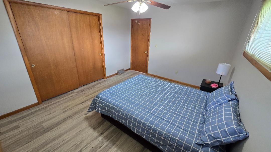1124 13th Avenue Fulton, IL 61252 - Photo 20 of 27 a bedroom with bed and wooden floor