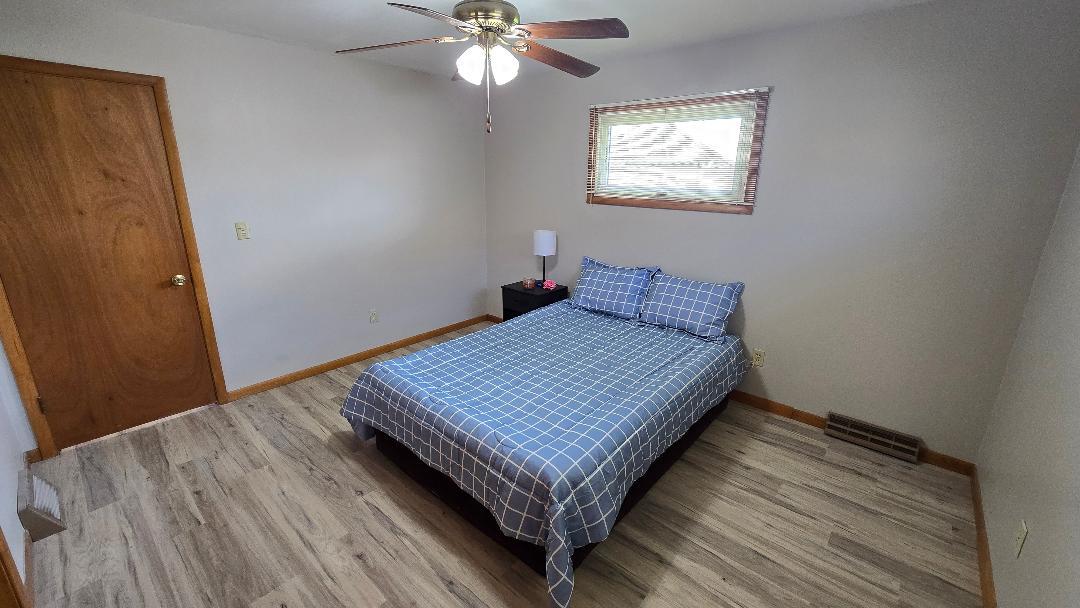 1124 13th Avenue Fulton, IL 61252 - Photo 21 of 27 a view of a room with wooden floor and fan