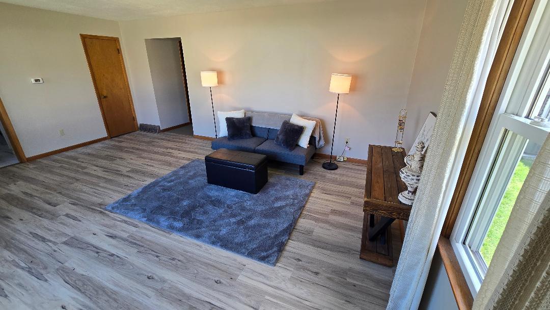 1124 13th Avenue Fulton, IL 61252 - Photo 7 of 27 a living room with furniture and a rug