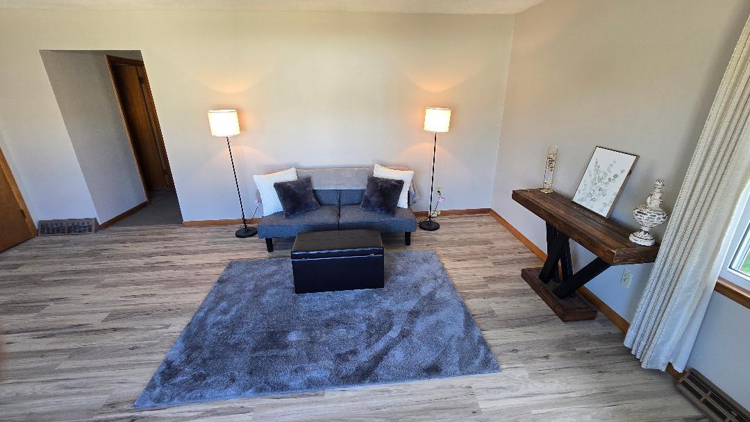 1124 13th Avenue Fulton, IL 61252 - Photo 8 of 27 a living room with furniture and a wooden floor