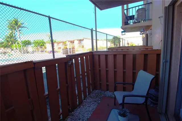 a view of a two chairs in the balcony