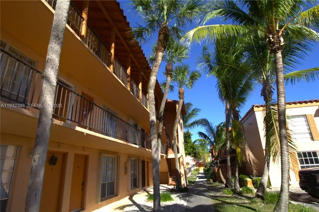 a view of a palm trees front of house