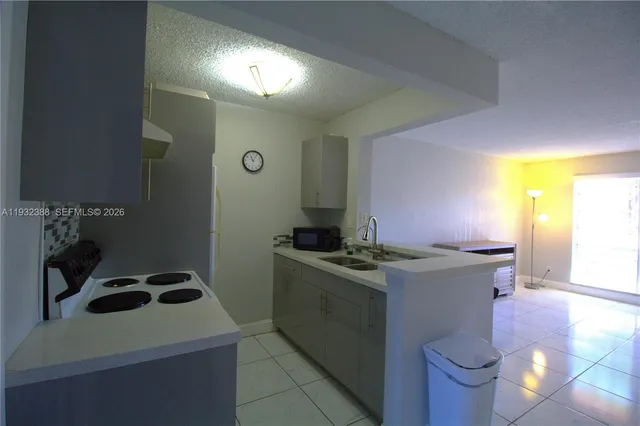 a kitchen that has a sink and a stove