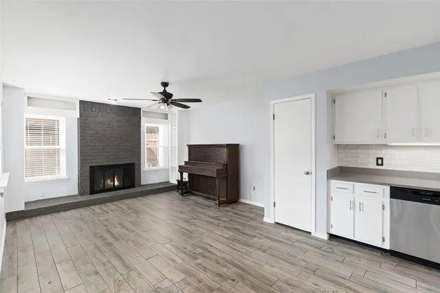 a living room with furniture a fireplace and a flat screen tv