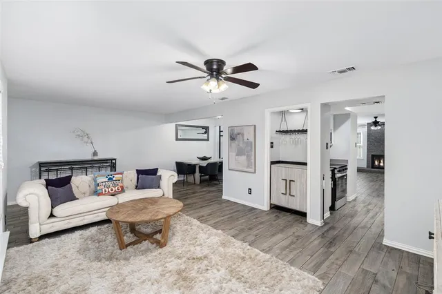 a living room with furniture and wooden floor