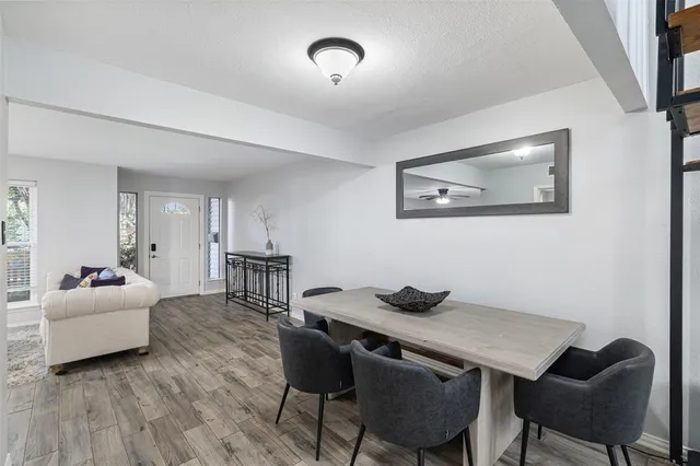 a view of a dining room with furniture and wooden floor