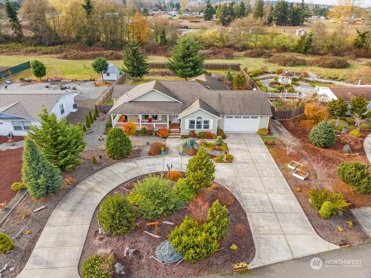 261 Chiesa Place Sequim, WA 98382 - Photo 1 of 39 an aerial view of a house with a yard tennis courts and ocean view
