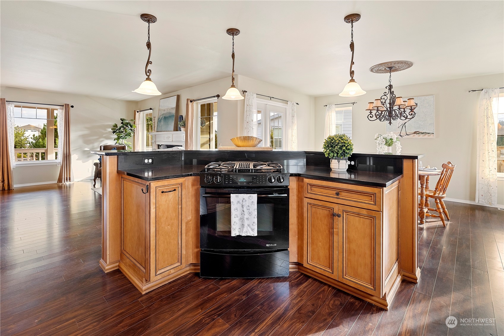 261 Chiesa Place Sequim, WA 98382 - Photo 11 of 39 a kitchen with stainless steel appliances granite countertop a stove and a wooden floor