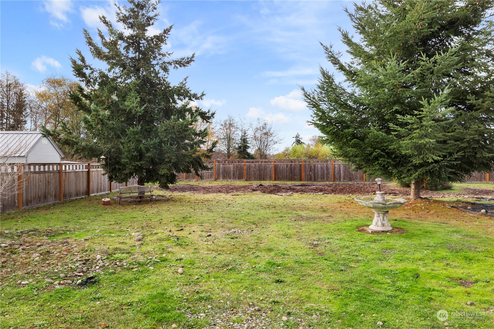 261 Chiesa Place Sequim, WA 98382 - Photo 29 of 39 a swimming pool with wooden fence and trees