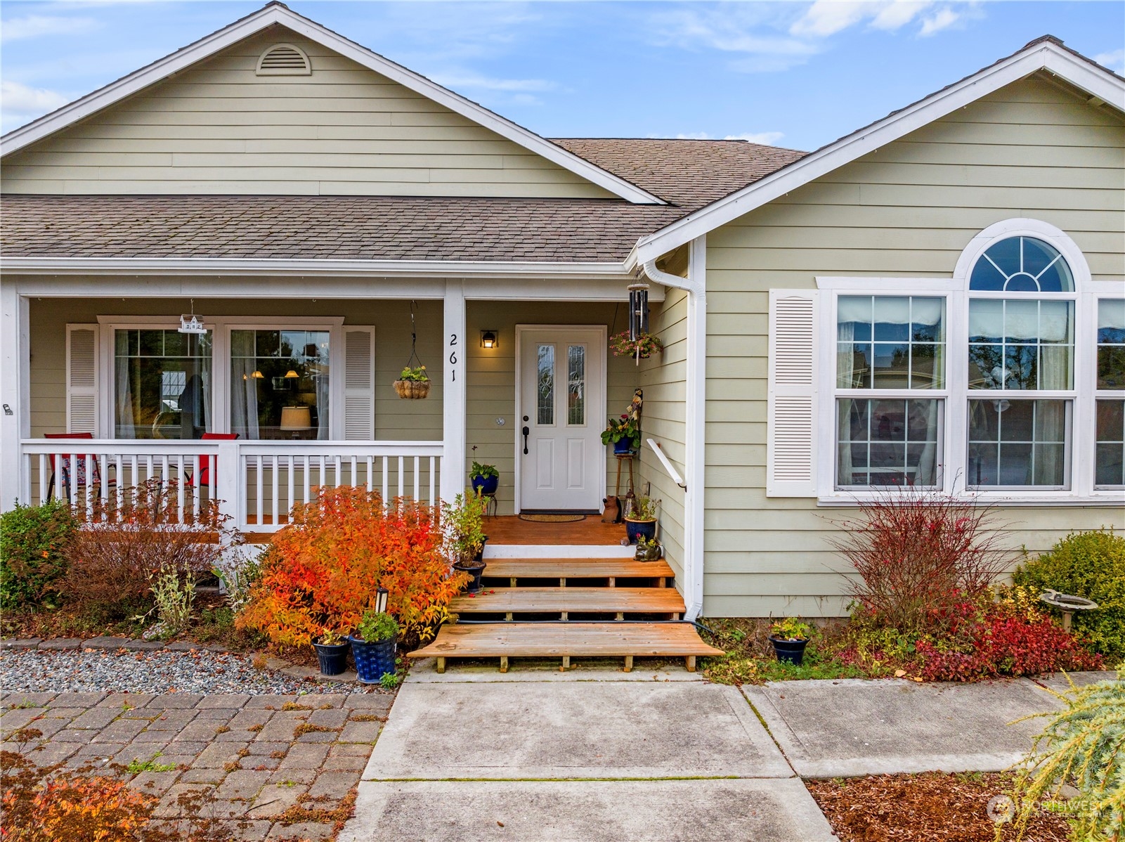 261 Chiesa Place Sequim, WA 98382 - Photo 36 of 39 a front view of a house with a yard and potted plants