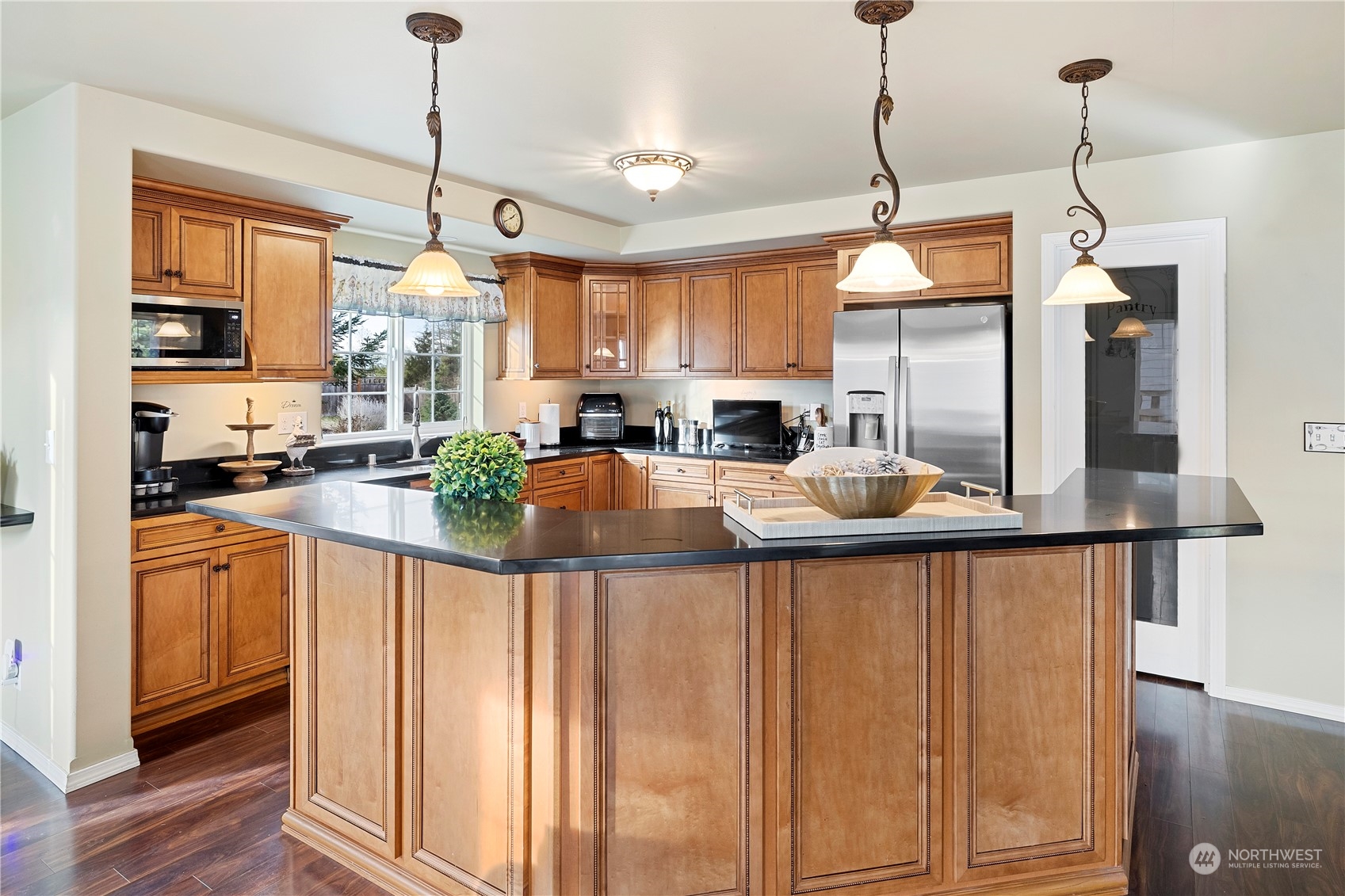 261 Chiesa Place Sequim, WA 98382 - Photo 4 of 39 a kitchen with stainless steel appliances granite countertop a sink a window and chairs