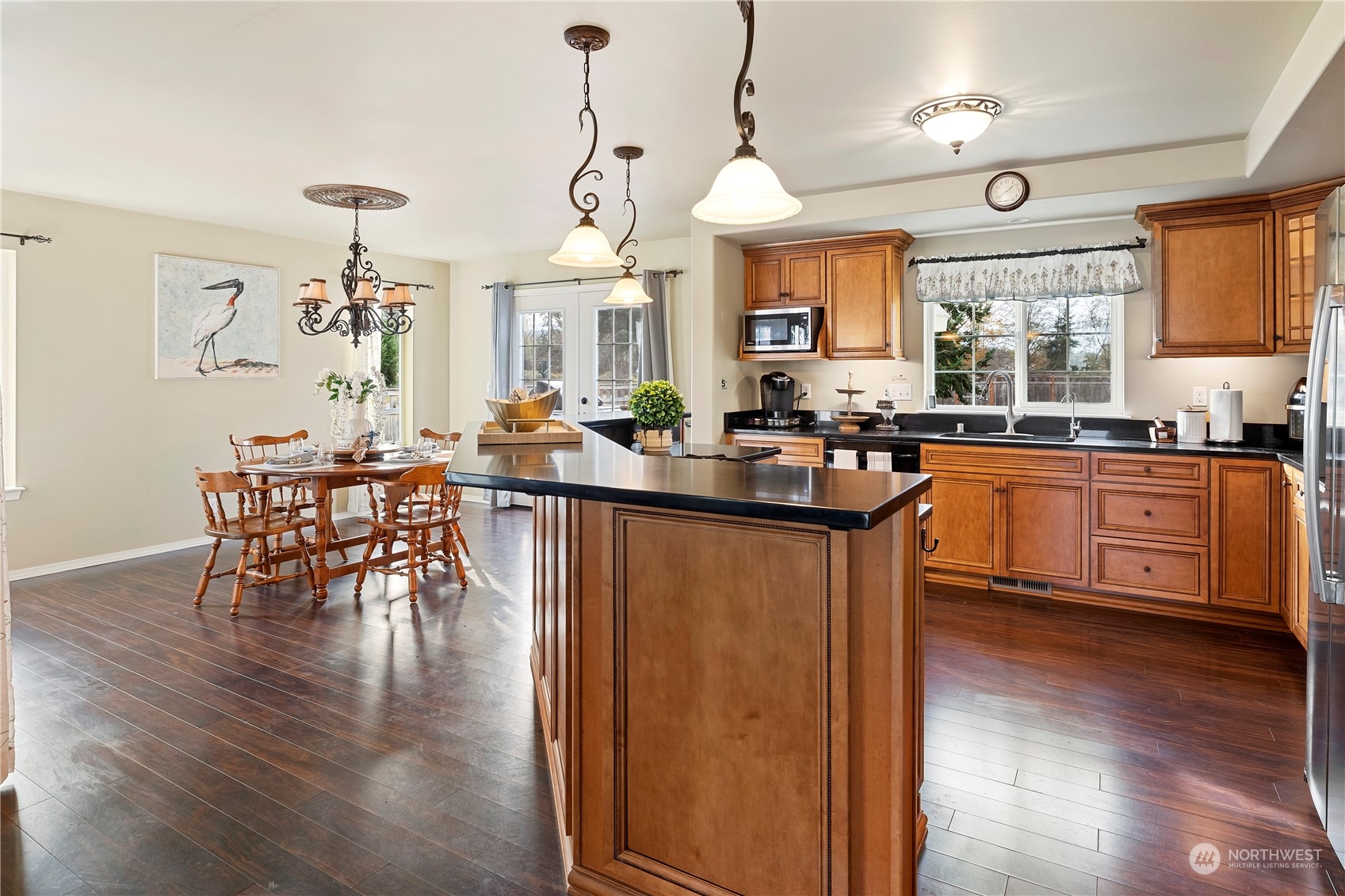 261 Chiesa Place Sequim, WA 98382 - Photo 8 of 39 a dining table with chairs and kitchen view