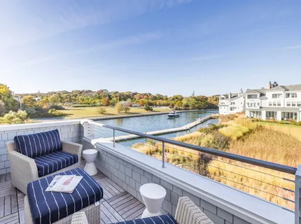 a roof deck with couches and city view
