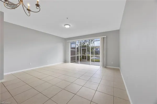 a view of a hallway with wooden floor and a window