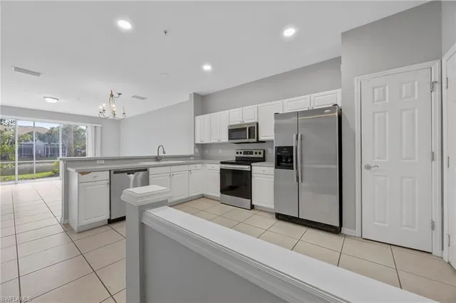 a kitchen with refrigerator and microwave