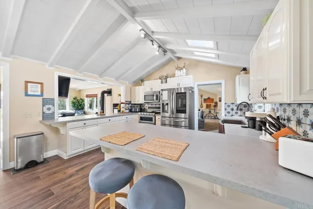 a dining room with furniture a rug and a chandelier