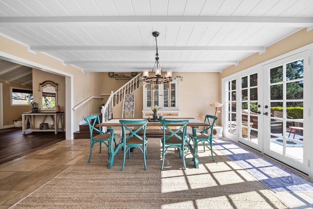 1569 Vía Monserate Fallbrook, CA 92028 - Photo 18 of 75 a dining room with furniture a rug and a chandelier