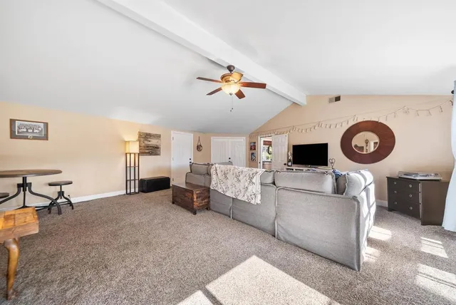 a spacious bathroom with a double vanity sink mirror and shower