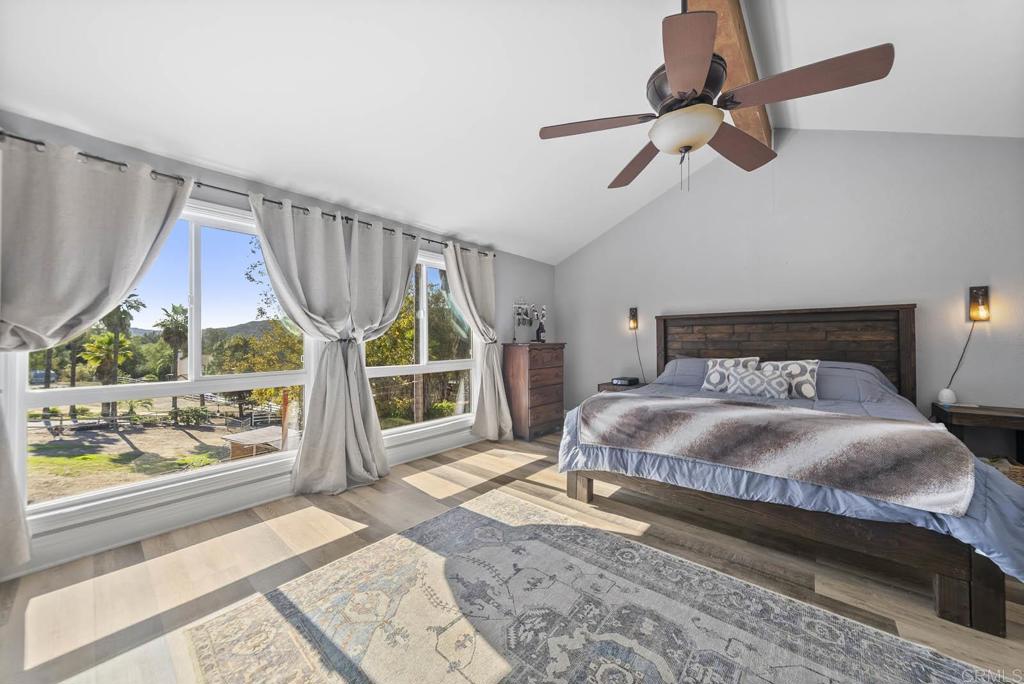 1569 Vía Monserate Fallbrook, CA 92028 - Photo 23 of 75 a bedroom with a bed and a large window