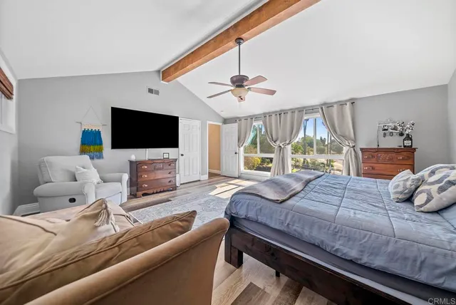 a bedroom with a bed and a wooden floor