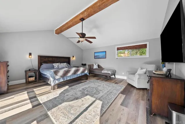 a bedroom with furniture a rug and a window