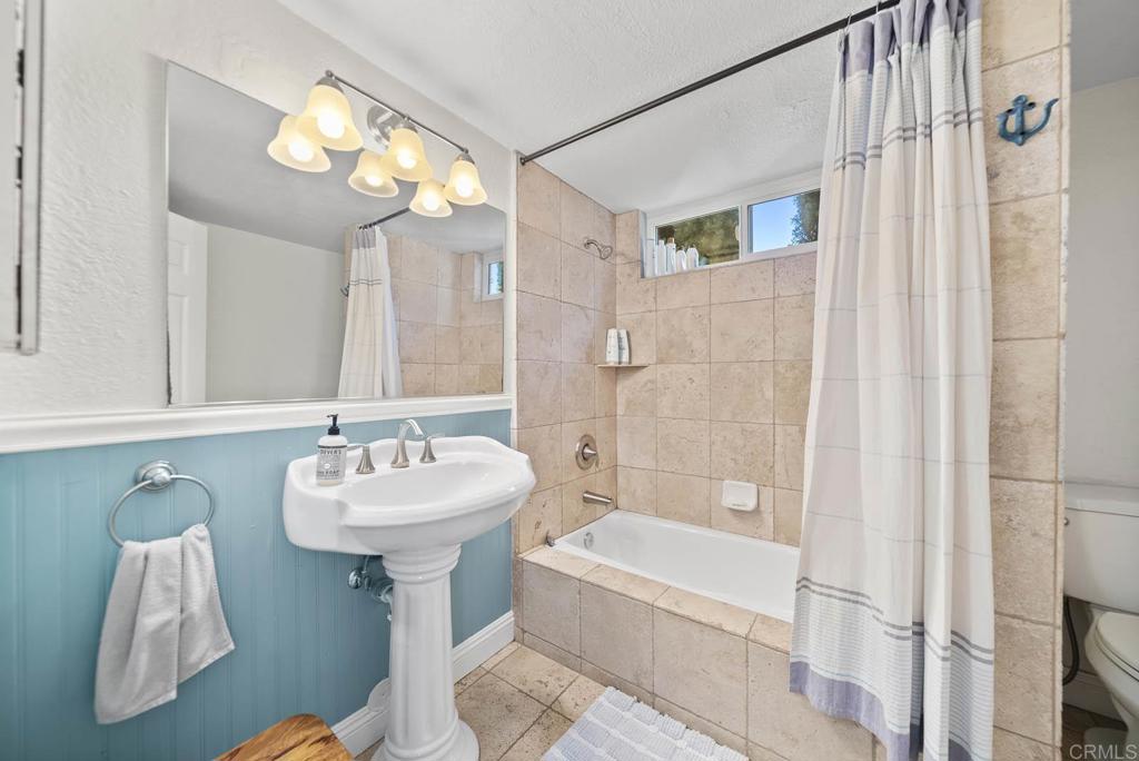 1569 Vía Monserate Fallbrook, CA 92028 - Photo 35 of 75 a bathroom with a sink mirror toilet and bathtub