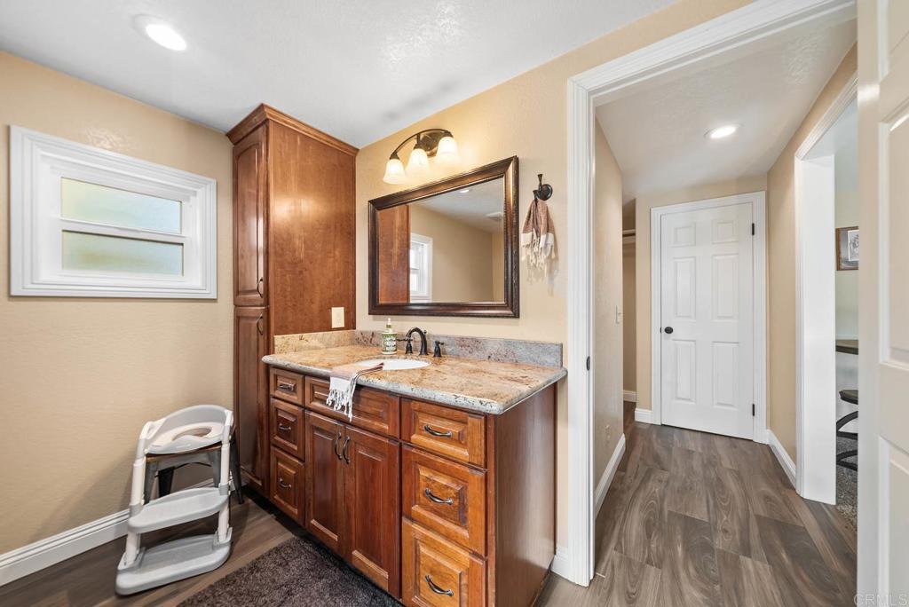 1569 Vía Monserate Fallbrook, CA 92028 - Photo 37 of 75 a bathroom with a sink a toilet and mirror