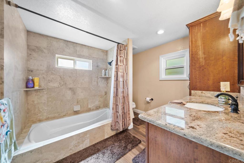 1569 Vía Monserate Fallbrook, CA 92028 - Photo 38 of 75 a bathroom with a granite countertop sink and a mirror