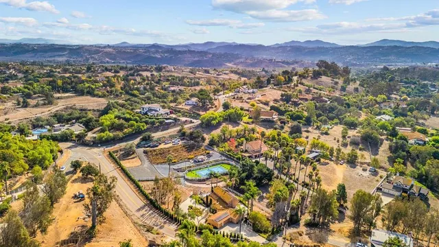 a view of a house with swimming pool and sitting area
