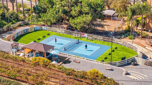 a living room with furniture a large window and wooden floor