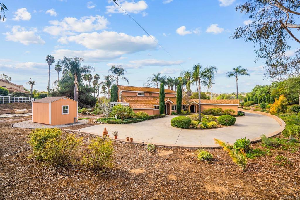 1569 Vía Monserate Fallbrook, CA 92028 - Photo 67 of 75 a view of a garden with a building in the background