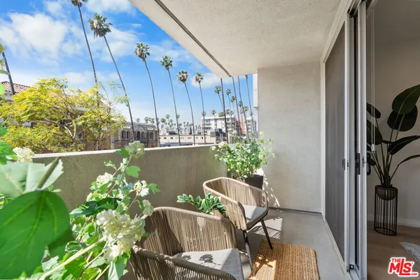 a view of a balcony with chairs