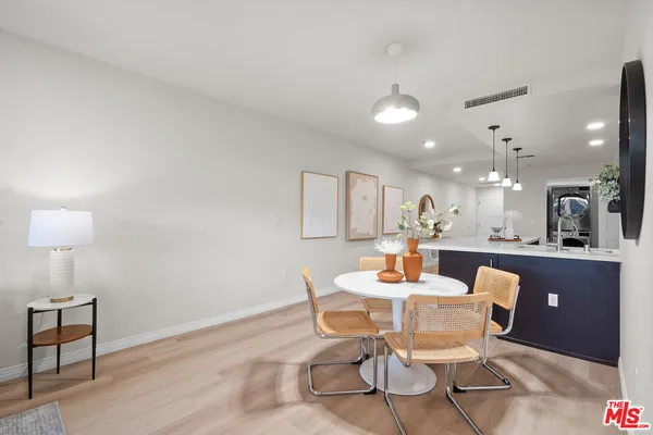 a dining room with furniture and wooden floor