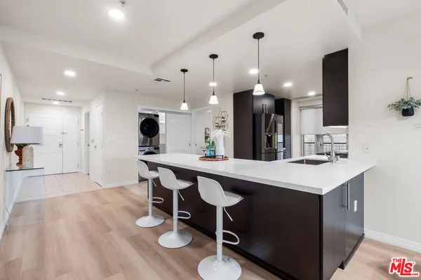 a kitchen with a sink a counter space and a dining table