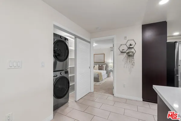 a view of a storage and utility room with washer and dryer