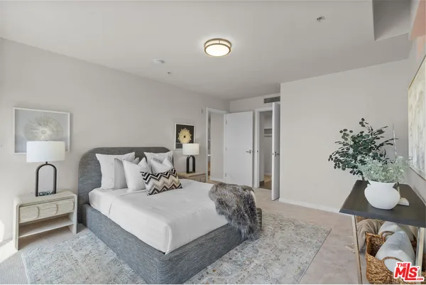 a bedroom with a bed and a potted plant