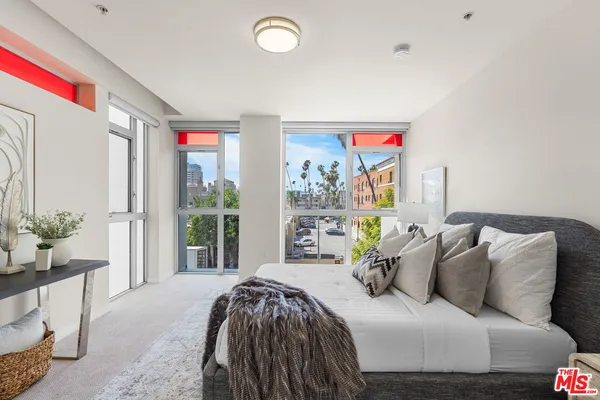 a bedroom with a balcony a bed and a couch