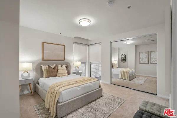 a bedroom with a bed and a couch