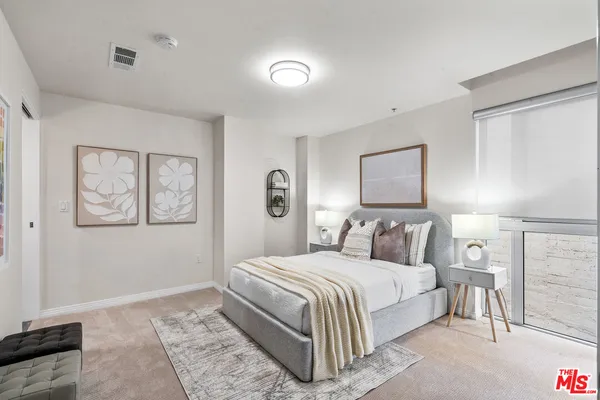 a bedroom with a bed and a night stand