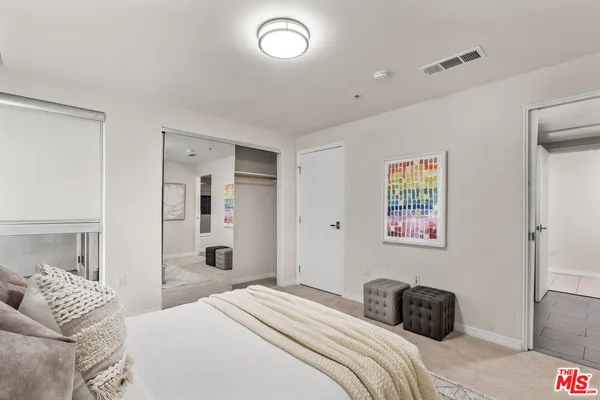 a bedroom with a bed and a couch