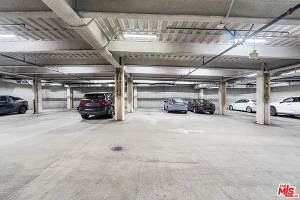 a view of parking garage with cars