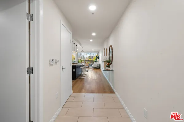 a view of a hallway with a livingroom and a couch
