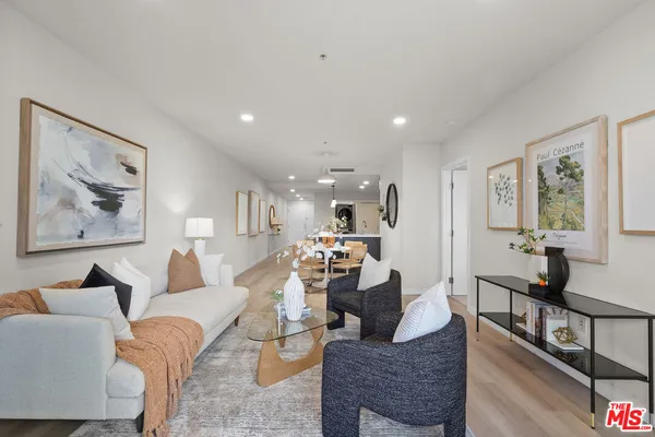 a living room with furniture and painting on the wall