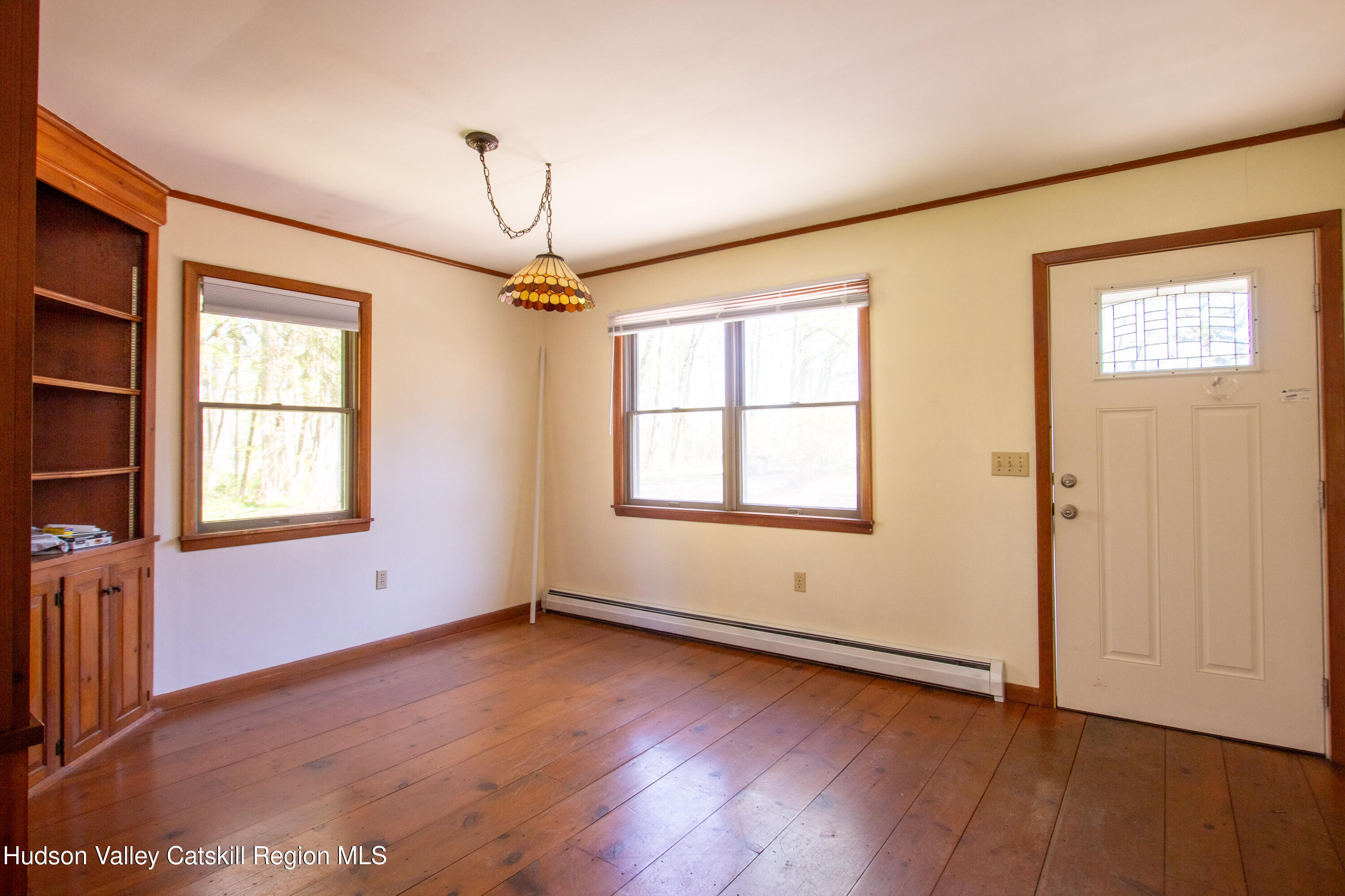 205 Fordham Road Valatie, NY 12184 - Photo 12 of 18 an empty room with wooden floor chandelier and windows